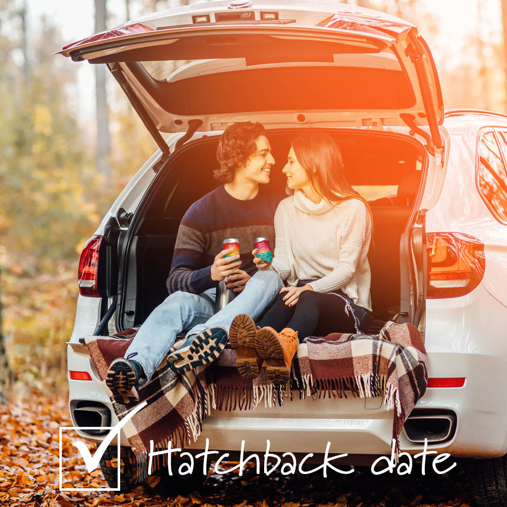Couple sitting on a blanket in the back of a hatchback car with Circle Back product